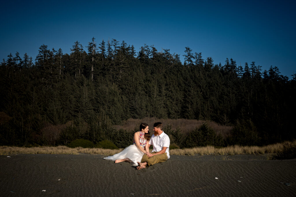 Lesley and Bryce sitting close together during their engagement session – natural light photography by Dan Berger.