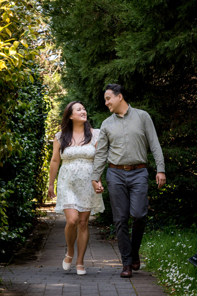 Julie and Derek, holding hands amidst the beautiful scenery, perfectly captured in this moment.