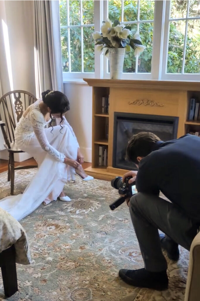 Dan Berger photographing a bride putting on her shoes at Sand Rock Farm in Aptos