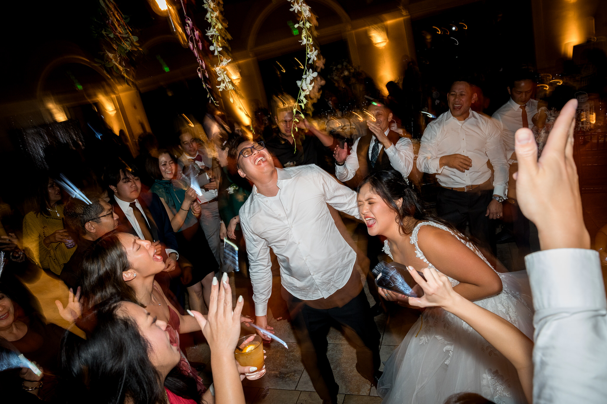 Bride and groom dancing with guests during a lively wedding reception at Casa Real in Pleasanton California, captured by a Northern California wedding photographer
