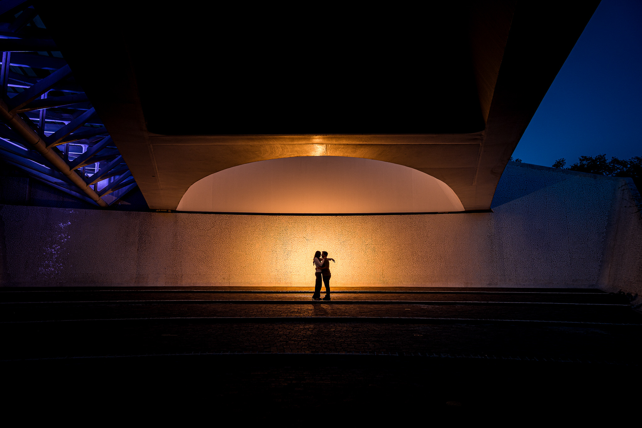 Couple silhouetted in an embrace under a bridge underpass at Turtle Bay, Redding