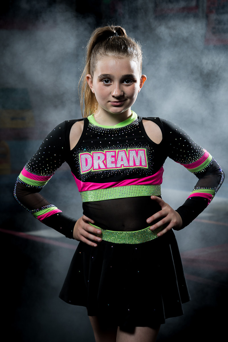 Portrait of Avery, an 11-year-old cheerleader at Dream Athletics in Samoa, showcasing her confidence and cheerleader spirit during a practice session.